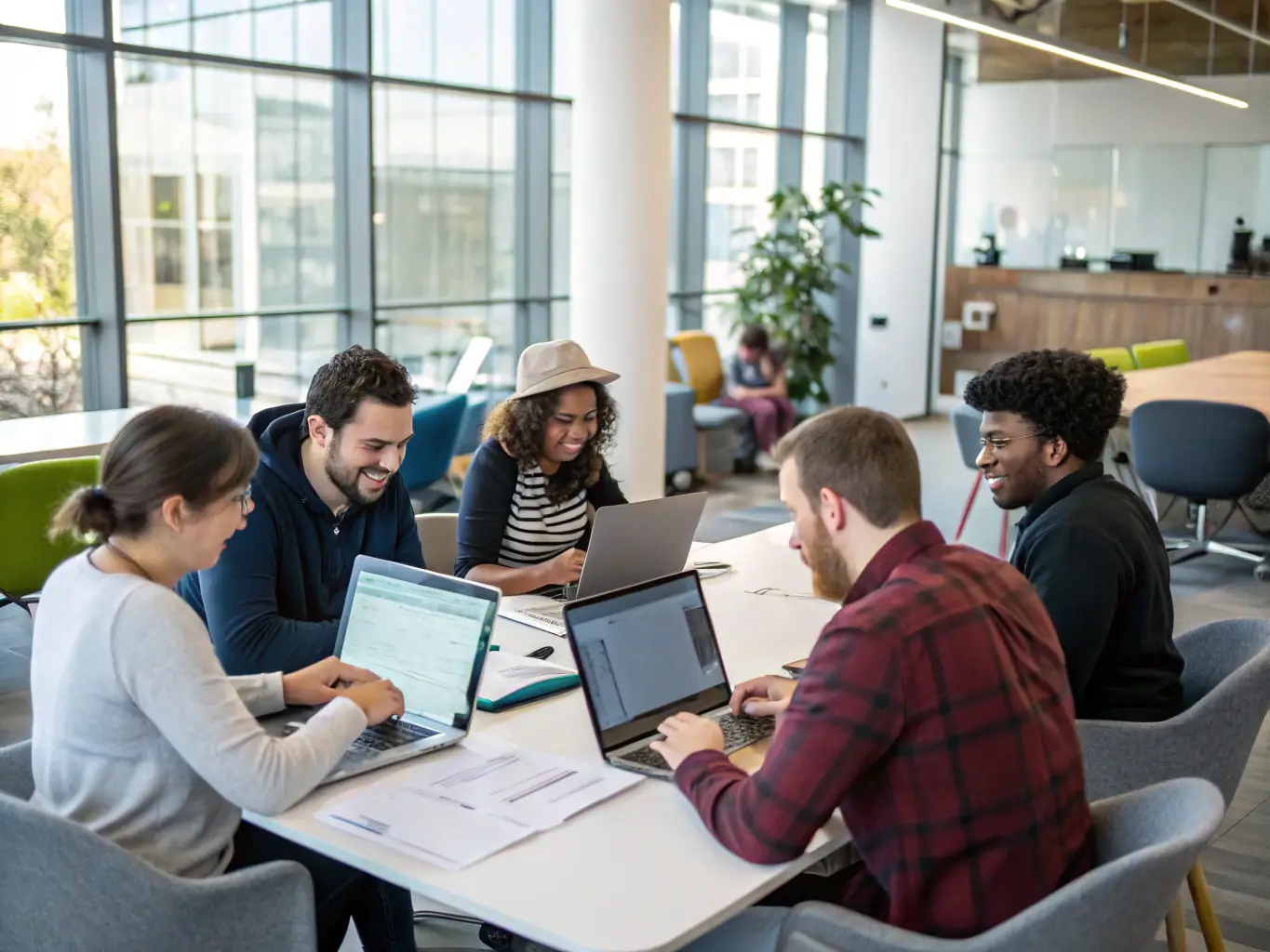 An image showing a team of tech experts brainstorming around a table filled with laptops and gadgets, representing technological innovation and collaboration.